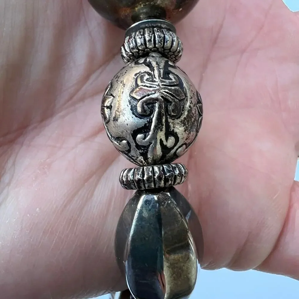 Tarnished silver color beaded necklace. Multiple shapes & sizes of silver color
